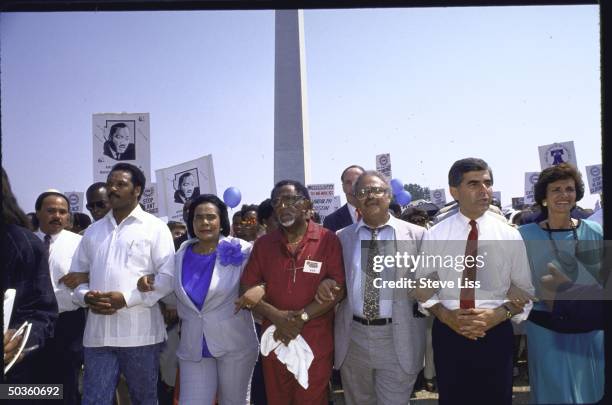 Presidential candidate Michael S. Dukakis and his wife Kitty walking with Coretta Scott King , Rev. Jesse Jackson and Dexter King during 25th...