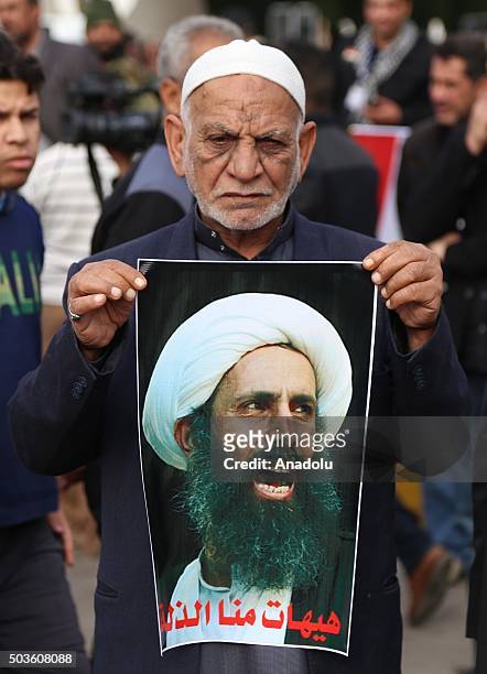 Demonstrator holds poster of Nimr Baqir al-Nimr during a protest against the execution of prominent Saudi Shia cleric Nimr Baqir al-Nimr by Saudi...