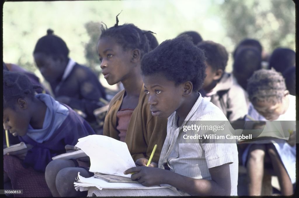 Children attending class at school run b