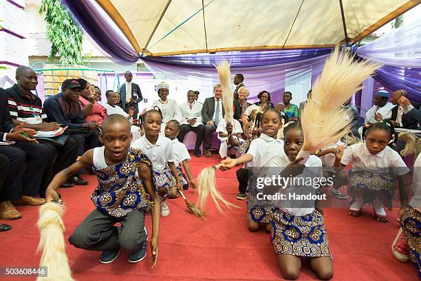 In this handout image provided by the International Monetary Fund, International Monetary Fund Managing Director Christine Lagarde watches orphan...