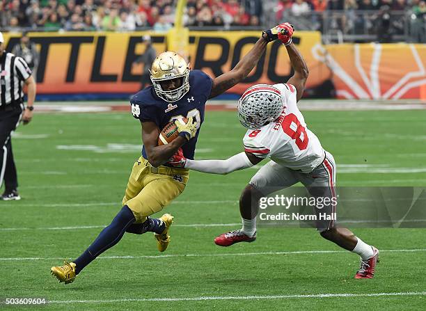 Running back Josh Adams of the Notre Dame Fighting Irish attempts to stiff arm cornerback Gareon Conley of the Ohio State Buckeyes during the first...