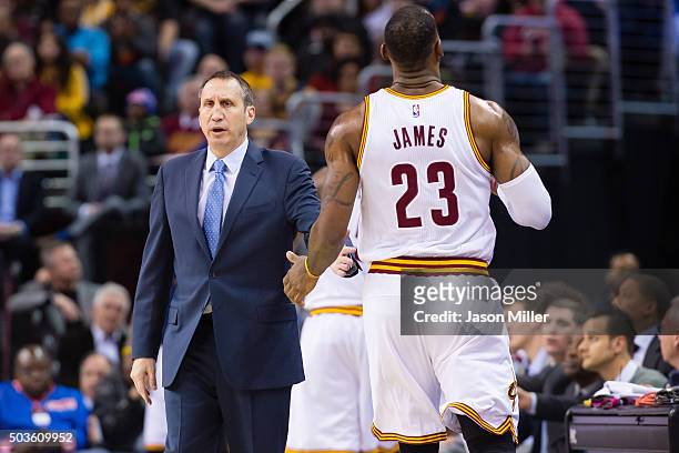 Head coach David Blatt talks to LeBron James of the Cleveland Cavaliers as James leaves the game during the first half against the Toronto Raptors at...