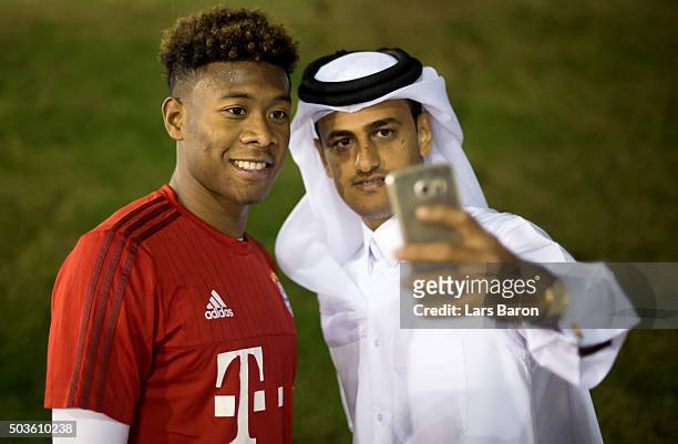 David Alaba poses with a fan after a training session at day one of the Bayern Muenchen training camp at Aspire Academy on January 6, 2016 in Doha,...