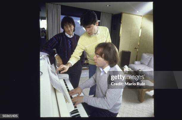 Composer Andrew LLoyd Webber playing piano while working on his new show with lyricists Don Black and Charles Hart .