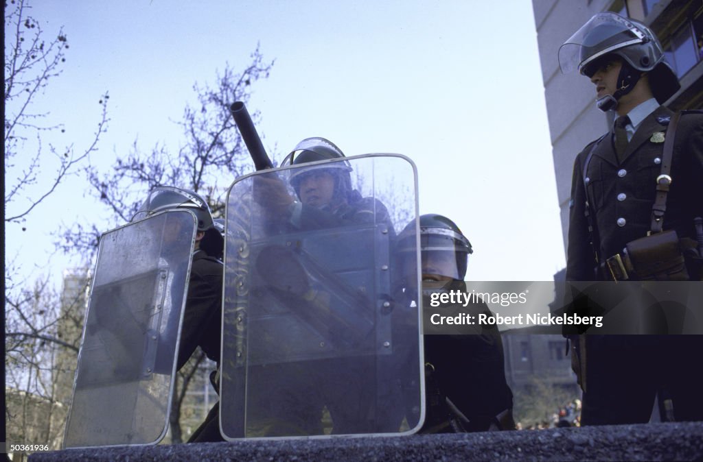 Troops equipped with shields, helmets an