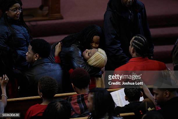 LaTisha Jones receives a hug as she attends the funeral for her mother Bettie Jones at New Mount Pilgrim Missionary Baptist Church January 6, 2016 in...