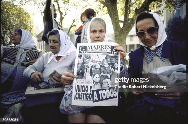 Mothers of Plaza de Mayo at demonstration regarding missing persons who disappeared during military regime with pictures of their relatives, signs,...