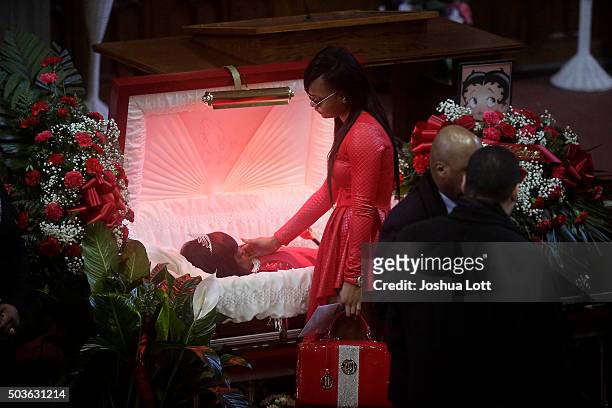 LaTonya Jones stands over her mother Bettie Jones during her funeral at New Mount Pilgrim Missionary Baptist Church January 6, 2016 in Chicago,...