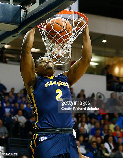 Jermaine Crumpton of the Canisius Golden Griffins dunks against the Monmouth Hawks defends during the first half of a college basketball game at the...