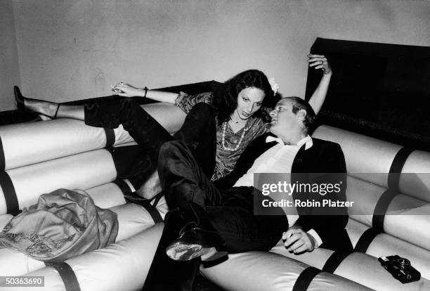 Clothing designer Diane Von Furstenberg lounging intimately with boyfriend, media mogul Barry Diller, at Studio 54.