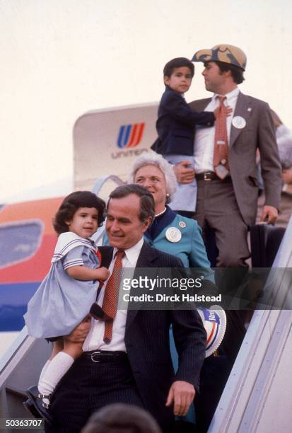 Republican VP candidate George Bush w. Granddaughter Noelle , wife Barbara , and son Jeb w. His son George disembarking fr. Plane.
