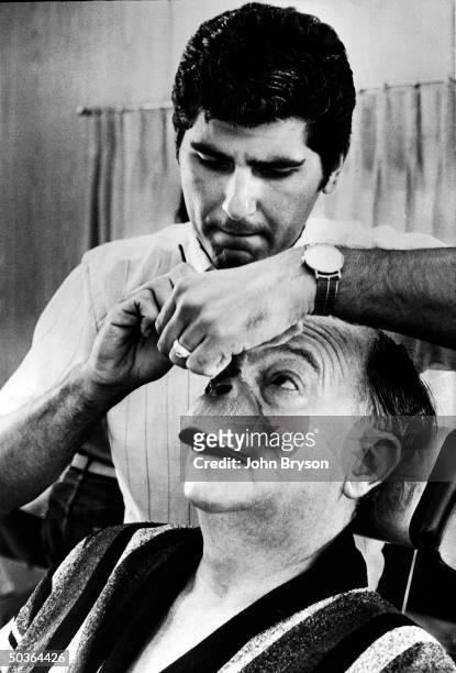 Special foam-rubber make-up being applied to actor Maurice Evans' face for his role as the simian heavy in the motion picture Planet of the Apes.