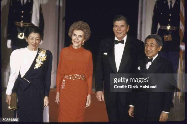 President Ronald W. Reagan and his wife standing with Japanese Crown Prince Akihito and his wife Crown Princess Michiko at the White House.