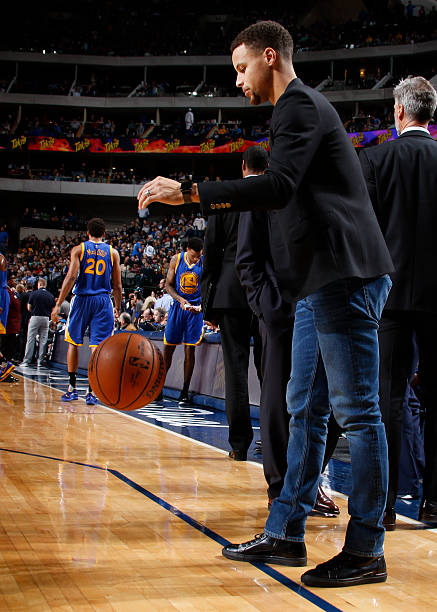 Stephen Curry of the Golden State Warriors dribbles the ball before the game against the Dallas Mavericks on December 30, 2015 at the American...