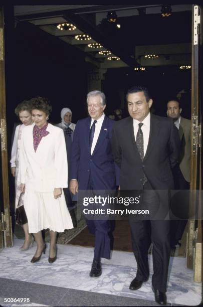 Former US President Jimmy E. Carter Jr. And his wife standing with Egyptian President Hosni Mubarak and his wife.