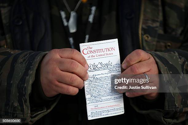 Member of an anti-government militia holds a copy of the U.S. Constitution at the Malheur National Wildlife Refuge Headquarters on January 6, 2016...