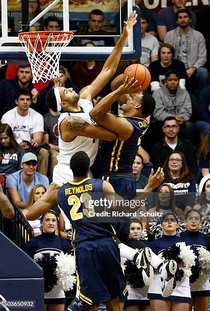 Jermaine Crumpton of the Canisius Golden Griffins is fouled by Chris Brady of the Monmouth Hawks during the second half of a college basketball game...