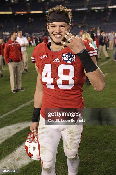 Jack Cichy of the Wisconsin Badgers show three for the three consecutive sacks against the USC Trojans during the National University Holiday Bowl at...