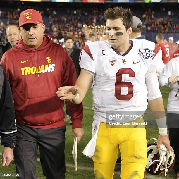 Head coach Clay Helton talks with Cody Kessler of USC Trojans during the National University Holiday Bowl at Qualcomm Stadium on December 30, 2015 in...