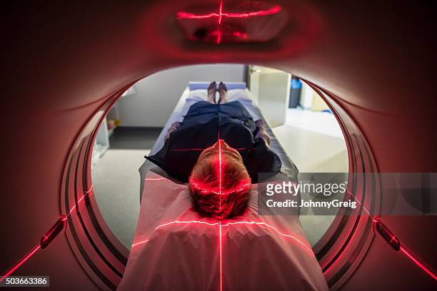 patient lying inside a medical scanner in hospital - corrects stockfoto's en -beelden