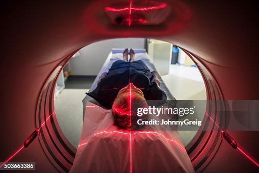 Patient lying inside a medical scanner in hospital Patient lying inside a medical scanner in hospital