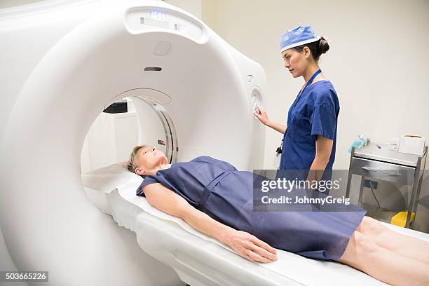 radiologist with female patient having cat scan in hospital - pet scan machine 個照片及圖片檔