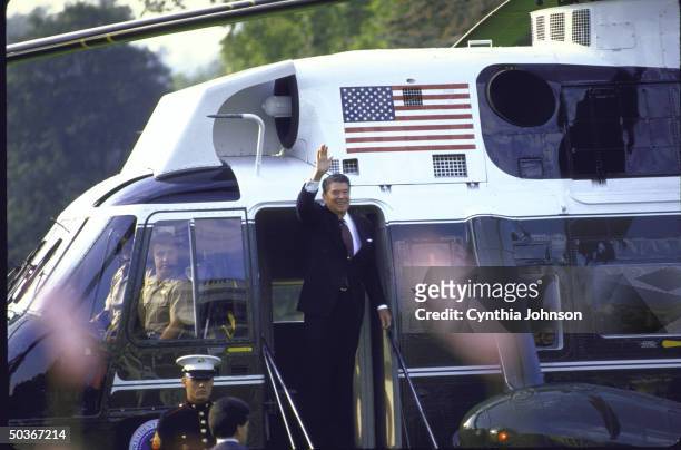 President Ronald W. Reagan on steps of Marine One copter, waving, before his departure for the Iceland Summit.