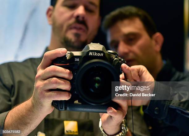 An attendee uses the Nikon D5 DSLR camera at the Nikon booth at CES 2016 at the Las Vegas Convention Center on January 6, 2016 in Las Vegas, Nevada....