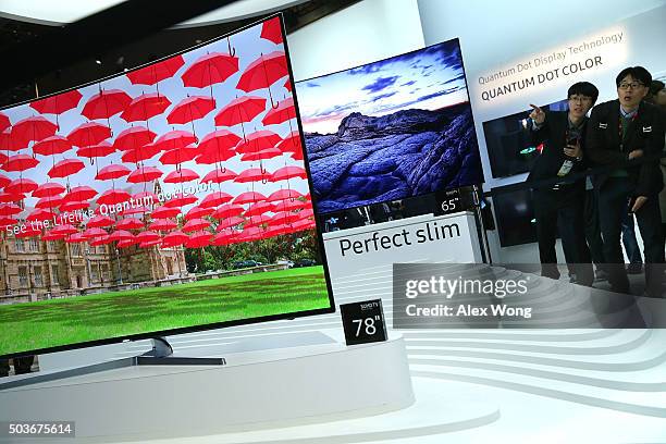 Show attendees check out the new Samsung 2016 SUHD TVs, which feature with Quantum dot display and bezel-less curved design, at CES 2016 at the Las...