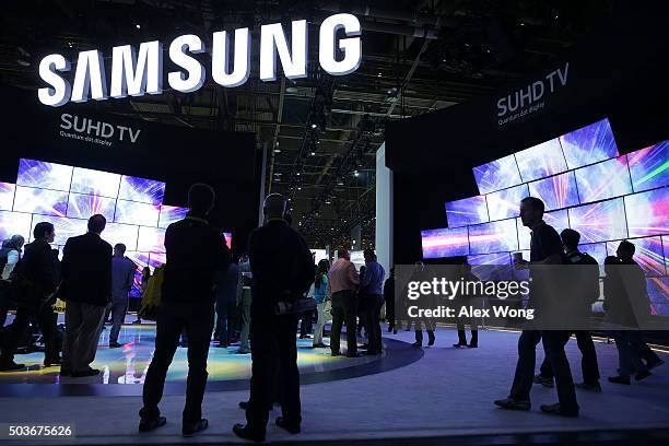 Show attendees check out the new Samsung 2016 SUHD TVs, which feature with Quantum dot display and bezel-less curved design, at CES 2016 at the Las...