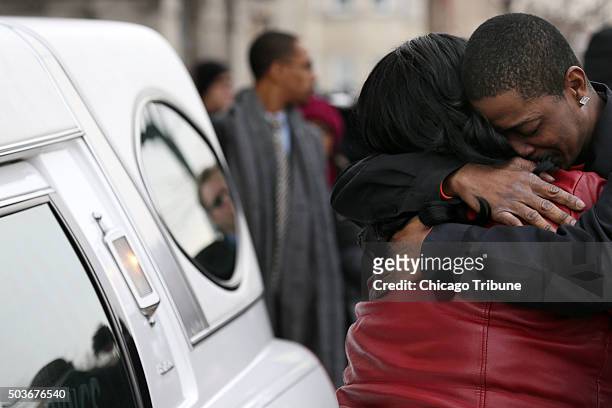Family members grieve over a hearse following the funeral for Bettie Jones Wednesday, Jan. 6 at New Mount Pilgrim Missionary Baptist Church in...