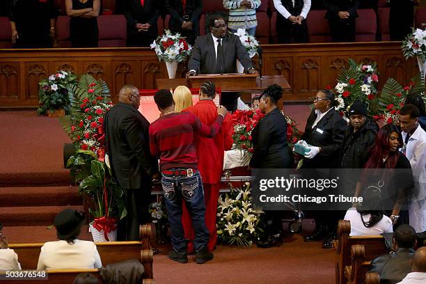 The family of Bettie Jones gathers at the front of the church by the casket during her funeral on Wednesday, Jan. 6 at New Mount Pilgrim Missionary...