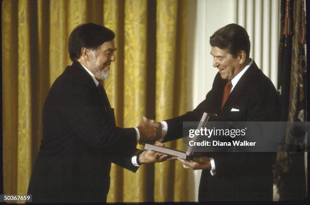 Florist Alan Lomax , accepting the National Medal of Arts from President Ronald W. Reagan.