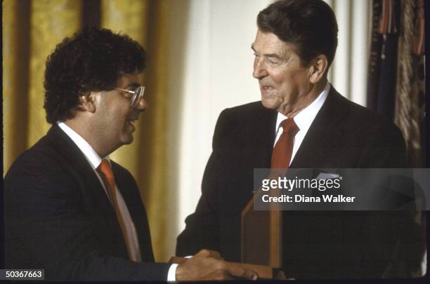 Film Director Frank Capra's son , accepting the National Medal of Arts on behalf of his father from President Ronald W. Reagan.