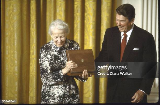 Texan art collector Mrs. John DeMenil , smiling after accepting the National Medal of Arts from President Ronald W. Reagan..