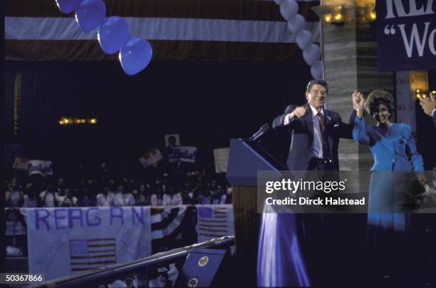 Republican Senator from Florida Paula Hawkins with President Ronald W. Reagan, raising hands joined in victory clasp, at her campaign rally.