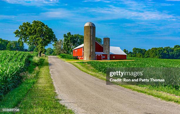 midwest farm with country road and red barn (p) - red barn corn field stock pictures, royalty-free photos & images