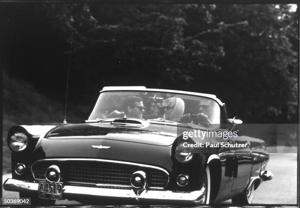Shortly after their marriage, American actress Marilyn Monroe and American playwright Arthur Miller ride in a Thunderbird convertible with Monroe's...
