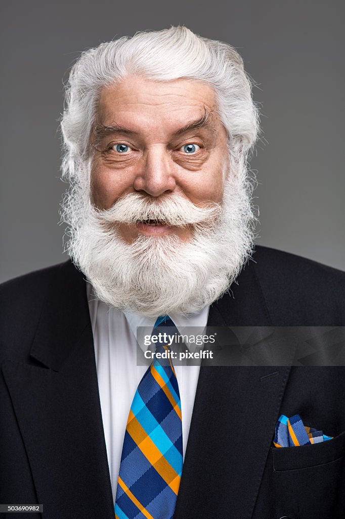 Portrait of senior man with white beard and mustache smiling