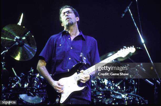 Guitarist Eric Clapton performing on stage.