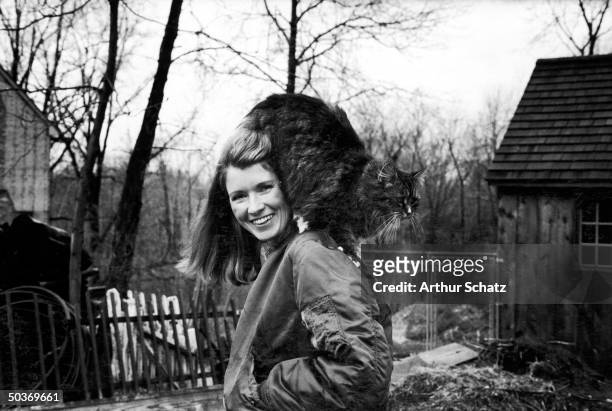 Caterer Martha Stewart outside in backyard with her pet persian cat perched on her shoulder, 24th March 1980.