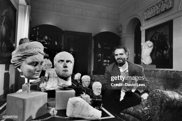 Designer Gianni Versace at home with his sculpture collection.