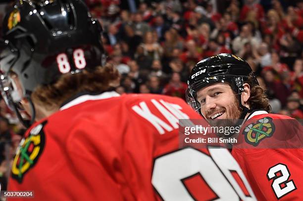 Duncan Keith of the Chicago Blackhawks smiles at Patrick Kane after the Blackhawks scored against the Pittsburgh Penguins in the first period of the...