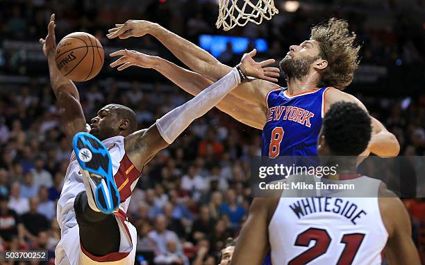 Dwyane Wade of the Miami Heat is blocked by Robin Lopez of the New York Knicks during a game at American Airlines Arena on January 6, 2016 in Miami,...