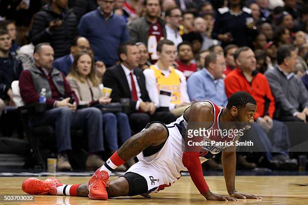 John Wall of the Washington Wizards looks down court after losing his footing and possession against the Cleveland Cavaliers during the second half...
