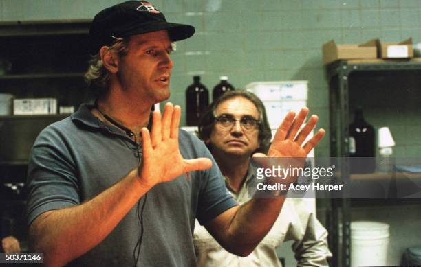 Chris Carter, executive producer & creator of cult TV series The X-Files, standing w. The show's director of photography John Baxter on the set of...