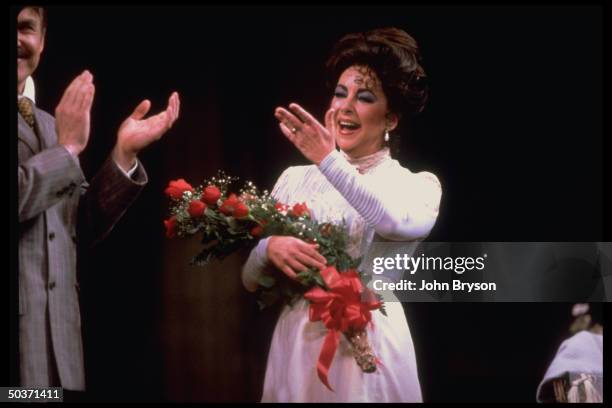 Actress Elizabeth Taylor taking curtain call in warm-up before opening of play The Little Foxes on Broadway.