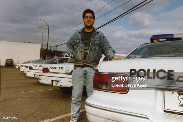 Detective Dan Pratt, who once arrested accused serial killer Glen Rogers on charges of breaking & entering, standing near row of police cars in...