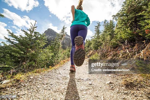 woman exercising for cross-country running - trail running stock pictures, royalty-free photos & images