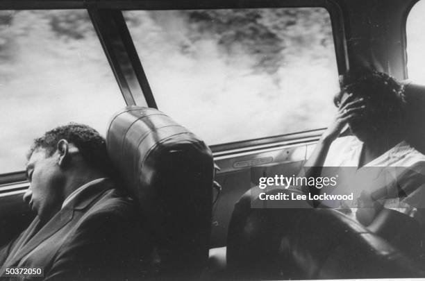 Freedom Riders seated aboard bus during trip from Montgomery, Alabama to Jackson Mississippi showing fatigue due to early morning start.